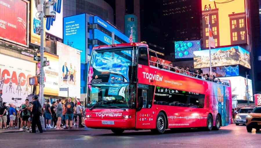 NYC: Skyline Night Tour on Double-Decker Bus - Times Square after dark sets the tone