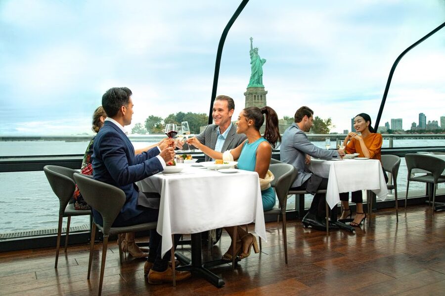 NYC: Thanksgiving Gourmet Lunch or Dinner Harbor Cruise - A Thanksgiving table with Manhattan outside the window